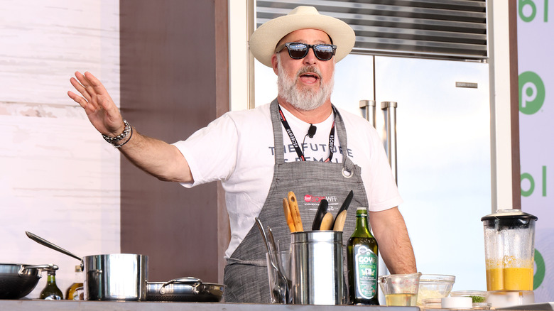 Andrew Zimmern wearing hat and sunglasses