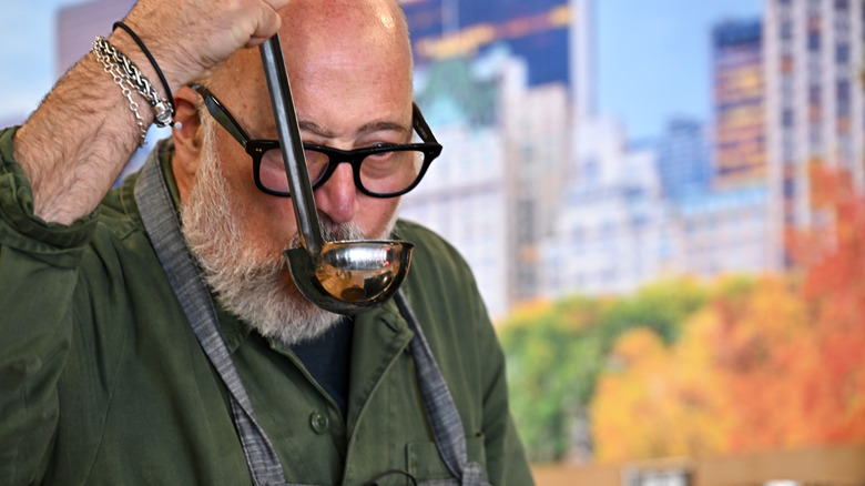 Andrew Zimmern sipping broth from ladle