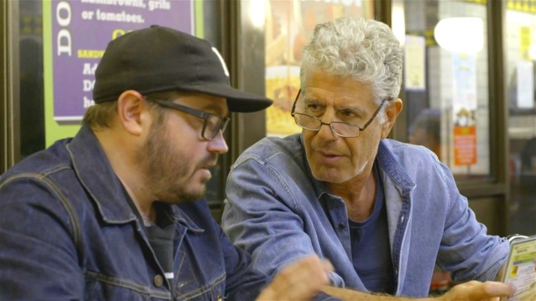 Anthony Bourdain looking at companion