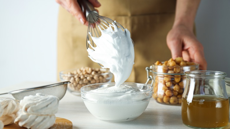 whipped aquafaba, chickpeas, and liquid aquafaba on a counter