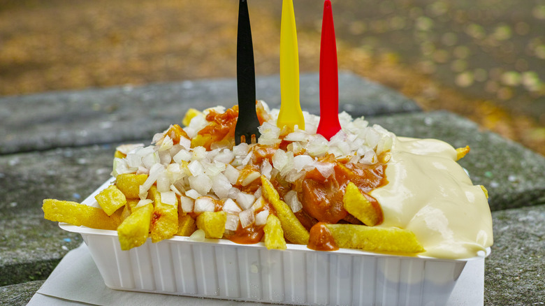 Belgian fries topped with onions and sauce