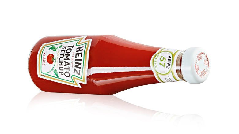 A bottle of Heinz ketchup on its side 