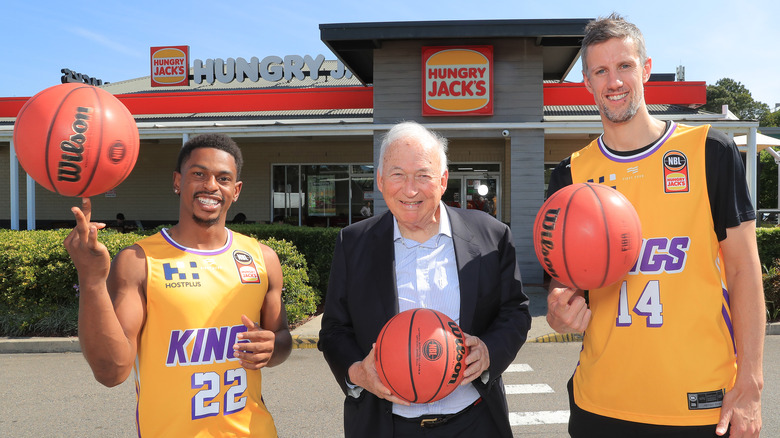 Jack Cowin with basketball players