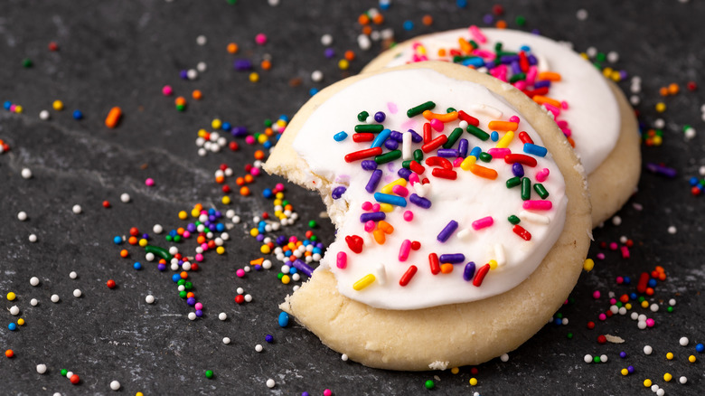 sugar cookies topped with frosting and sprinkles