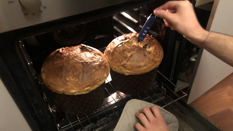 Person sticking thermometer in pastry