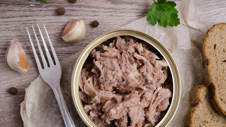 Opened chicken tin wooden background