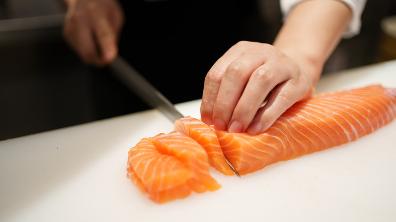 Chef cutting raw fish