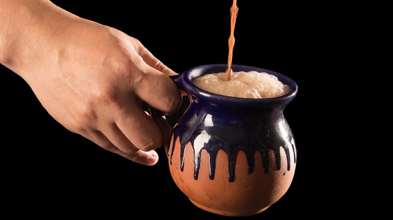 Hot chocolate poured into mug