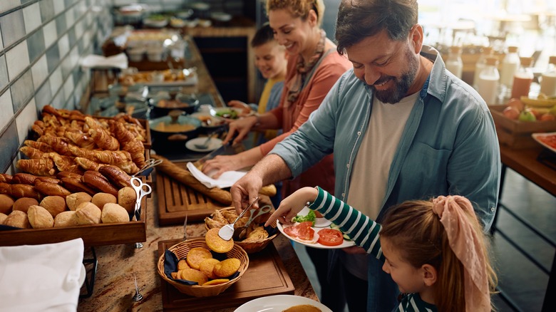 family enjoys hotel breakfast buffet