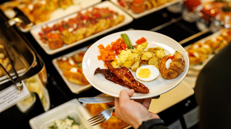 Person eating at hotel breakfast buffet