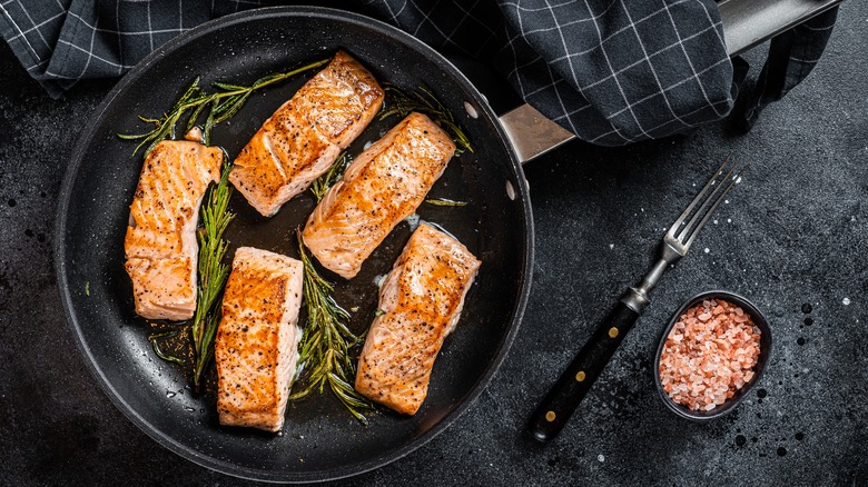 five salmon filets in skillet