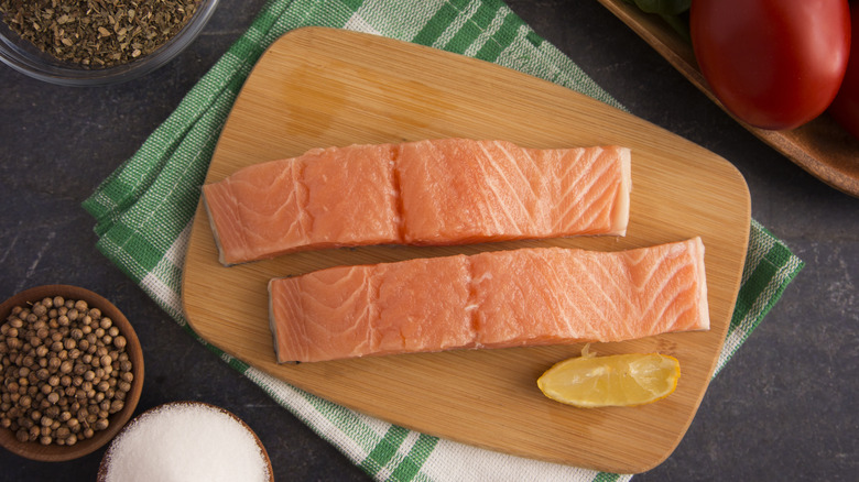 raw salmon fillets on wood