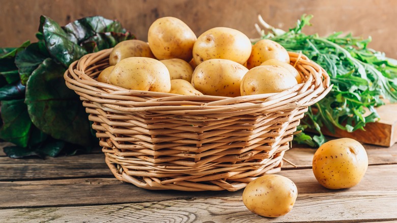 A bunch of potatoes in a basket.