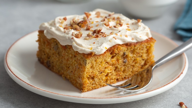 carrot cake slice with nut garnish