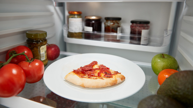 Slice of pizza in a fridge