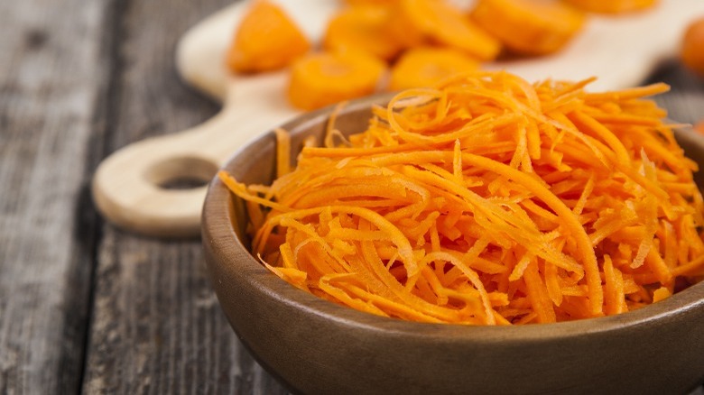 Shredded carrots in wooden bowl