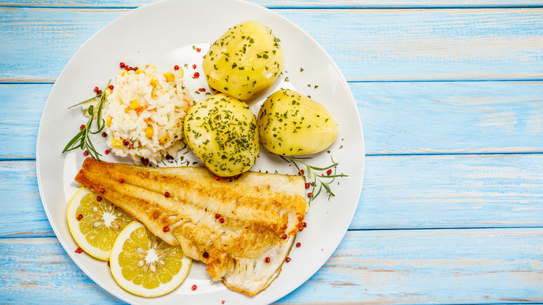 Cooked flounder with potatoes and rice