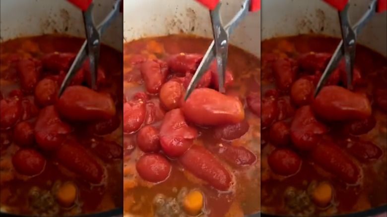 cutting tomatoes with red scissors