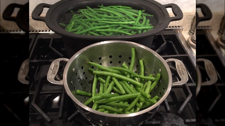 Green beans in a pot and strainer