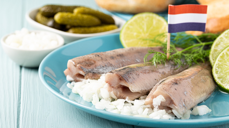 Prepared herring on plate with onions