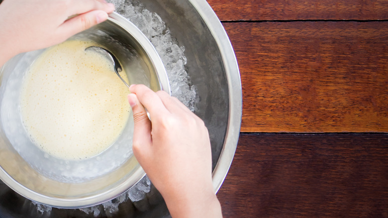 Hands mix ice cream in bowl