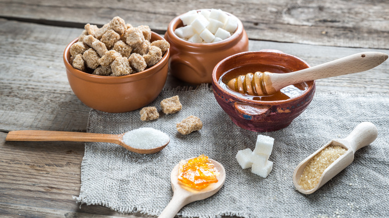 various sugar and bowl of honey