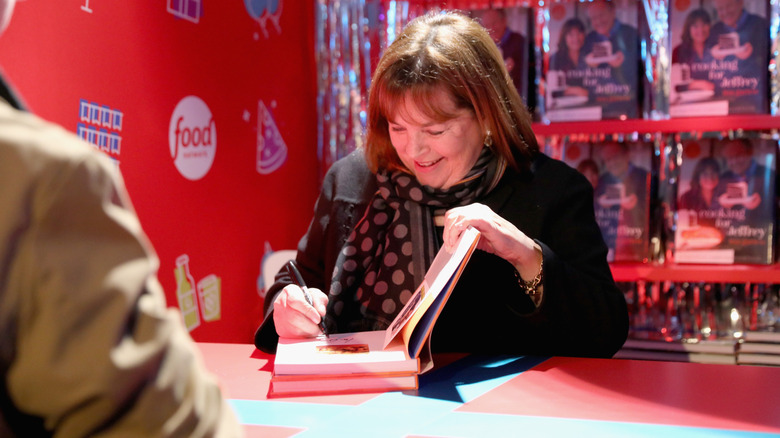 Ina Garten signing a cookbook