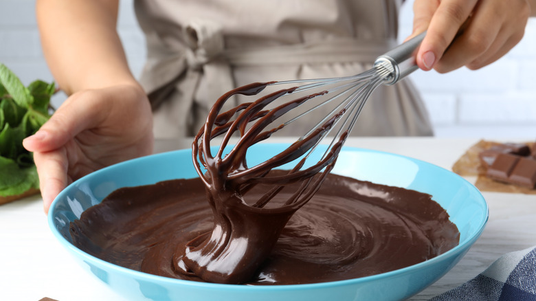 woman whisking chocolate pudding