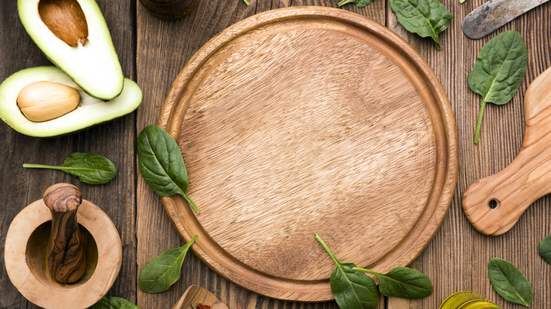 Wooden cutting board with avocado