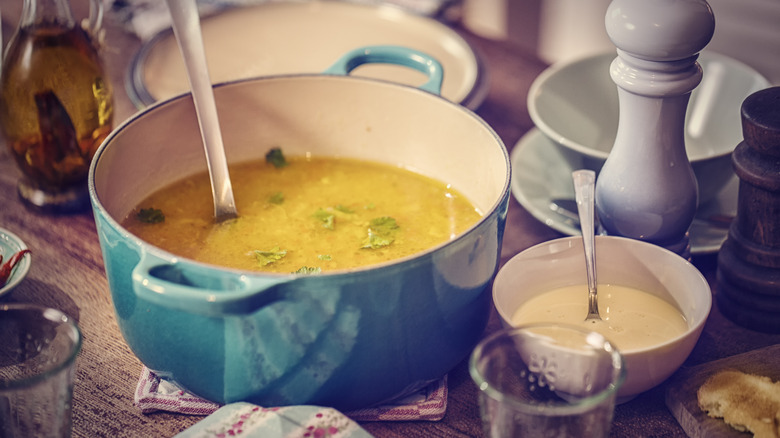 Adding herbs to soup pot