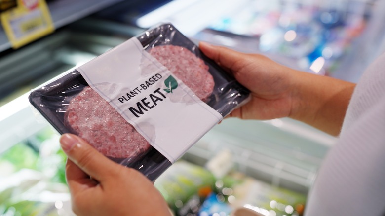 Person holding plant based meat package