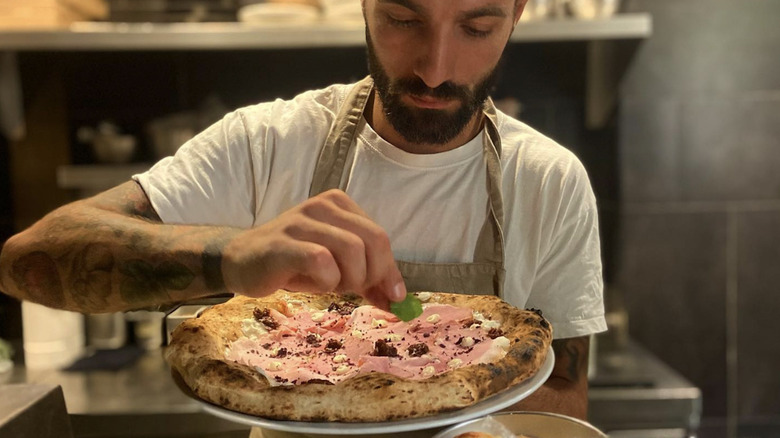 Sartoria Panatieri worker preparing pizza