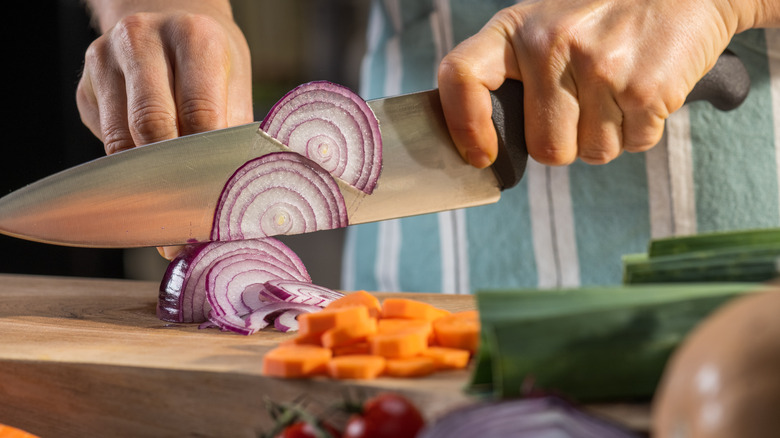 person slicing onions