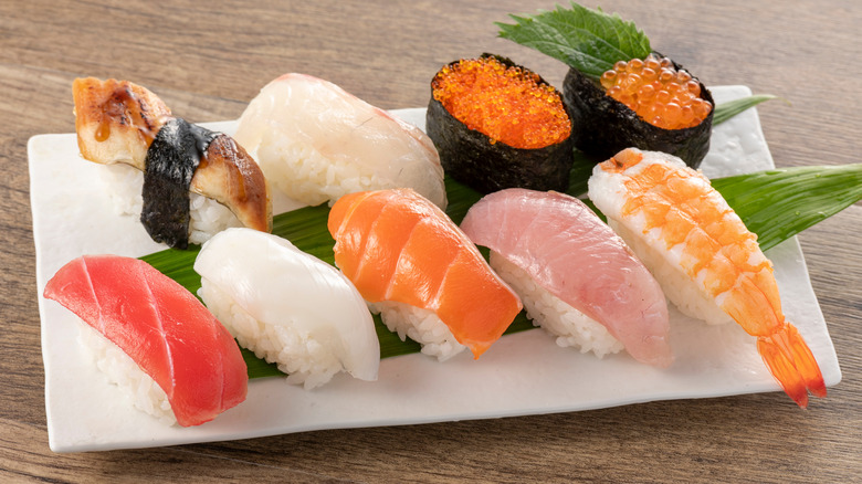  nigiri sushi assortment on white plate