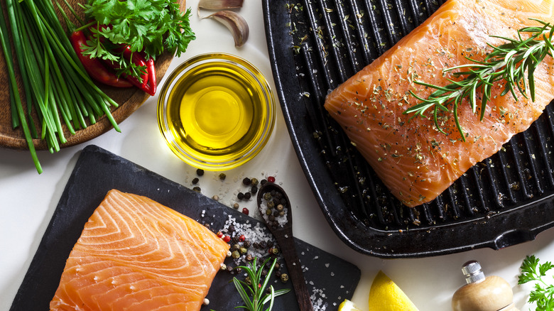 raw salmon filets on cast iron skillet with oil