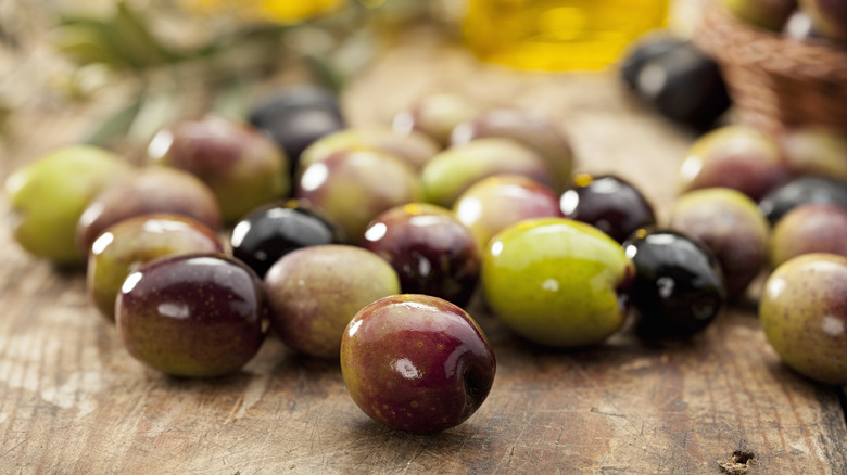 Fresh olives on wooden table