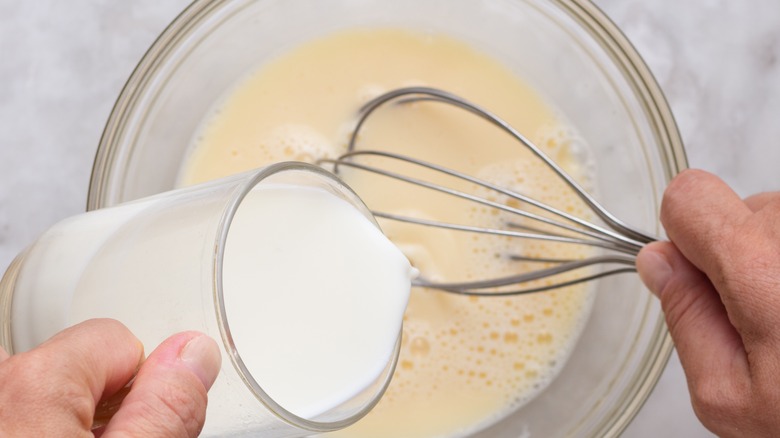 Whisking milk into a batter