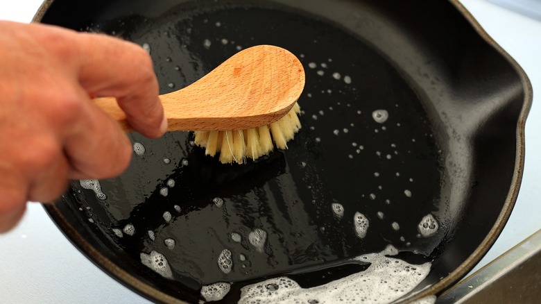 Scrub soapy cast iron skillet 