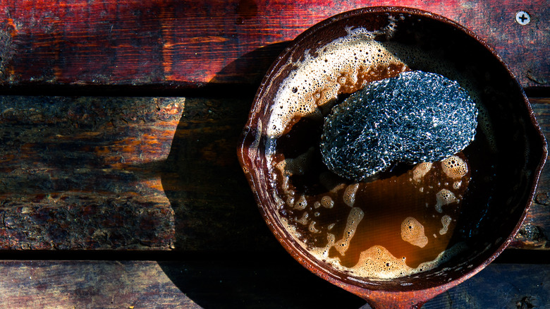 Dirty cast iron skillet wooden table 