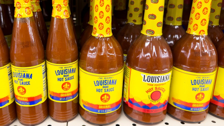 Bottles of The Original Louisiana Brand hot sauce on store shelf