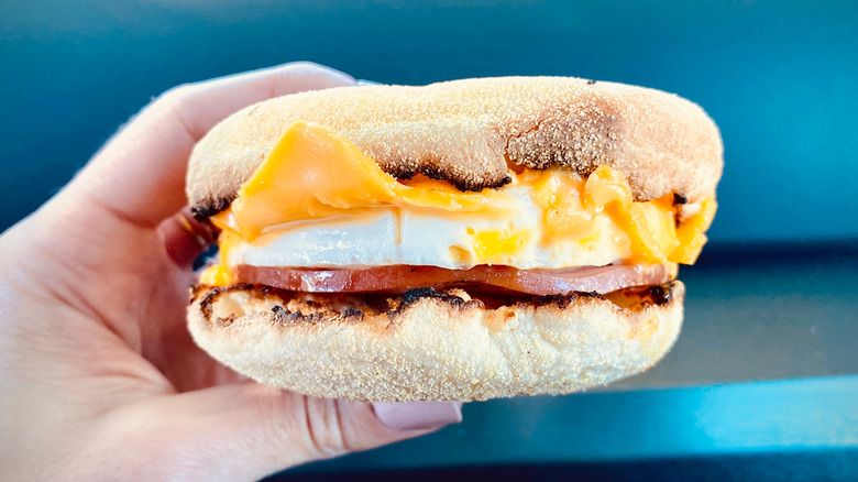 McDonald's Egg McMuffin in hand