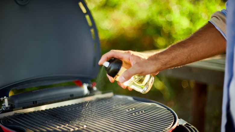 spraying oil on a grill