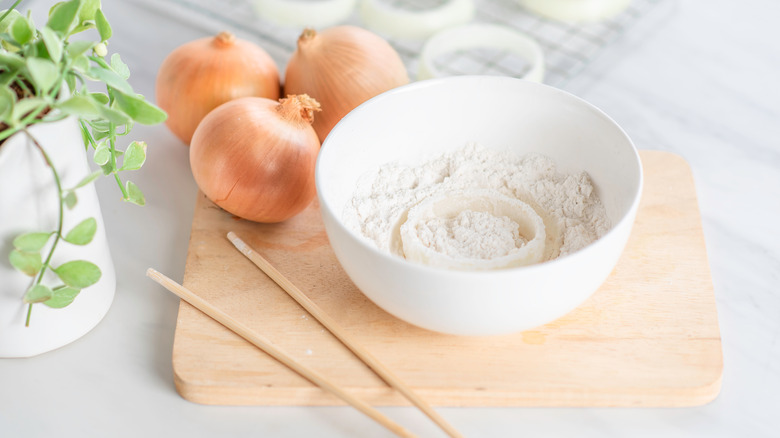 raw onion ring in flour