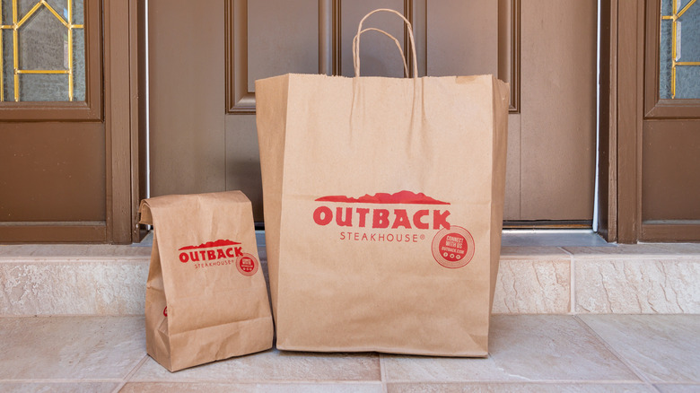 Two bags of Outback Steakhouse takeout