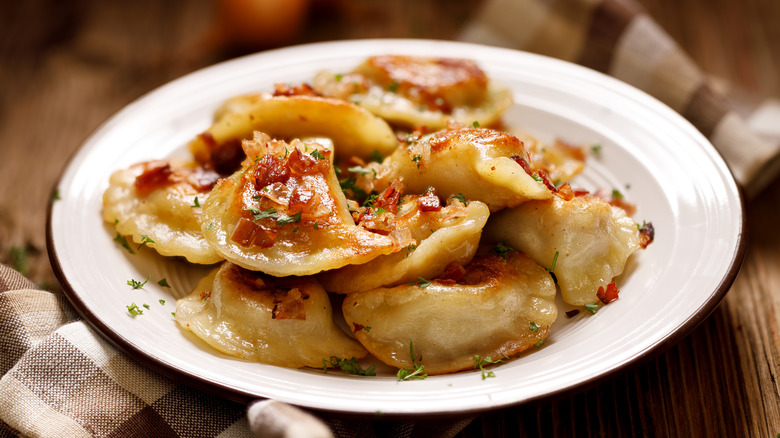 cooked pierogi served on white plate