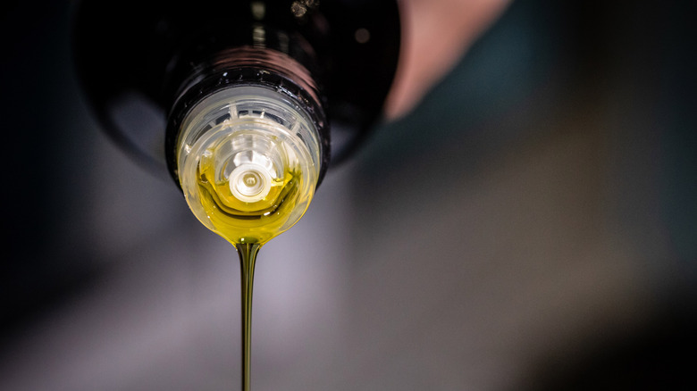 olive oil being poured from bottle