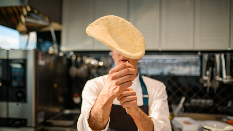 pizza chef throwing pizza dough