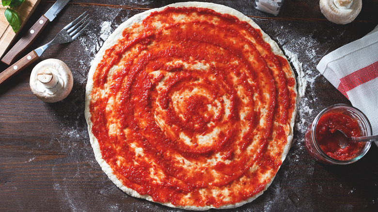 pizza base with pizza sauce