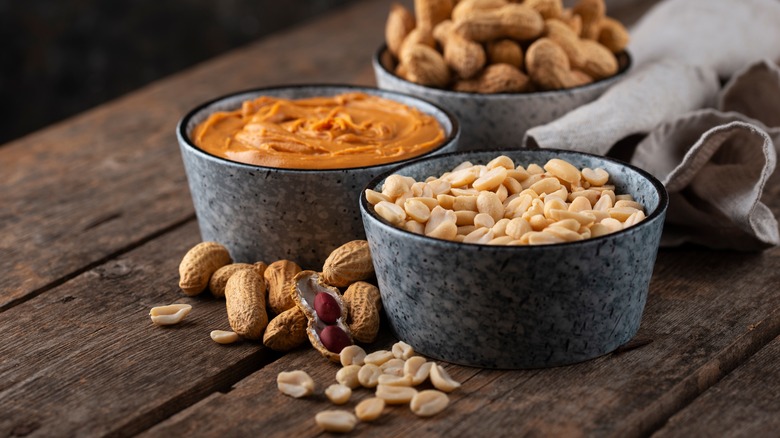 bowls filled with peanuts and peanut butter