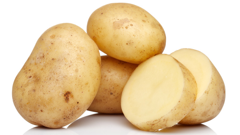 Sliced potatoes on white background